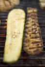 Courgettes on a barbecue rack outdoors — Stock Photo