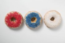 Three doughnuts with sprinkles — Stock Photo