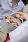 Hand holding tin of blueberry muffins — Stock Photo