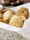 Raisin scones in biscuit tin — Stock Photo