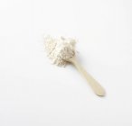 Wholemeal wheat flour with wooden spoon — Stock Photo