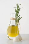 Оливковое масло в графине с чесноком — стоковое фото
