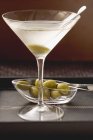 Glass of Martini with olives — Stock Photo