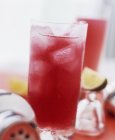 Closeup view of red fruit cocktail with ice — Stock Photo