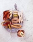 Raw and grilled sausages — Stock Photo