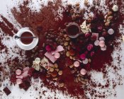 Chocolates and cocoa powder — Stock Photo