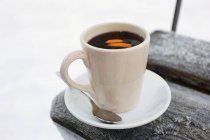 Hot punch in white cup — Stock Photo