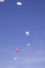Visão diurna de balões de ar com letras flutuando no céu — Fotografia de Stock