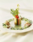 Closeup view of vegetable terrine with herb salad — Stock Photo