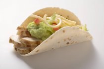 Folded tortilla filled with chicken — Stock Photo