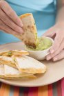 Hands dipping tortilla — Stock Photo