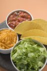 Tacos and filling ingredients — Stock Photo