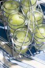 Closeup view of water glasses with green grapes in glass carrier — Stock Photo
