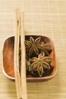Cinnamon sticks in wooden bowl — Stock Photo