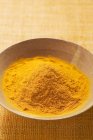 Turmeric in wooden bowl — Stock Photo
