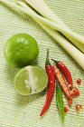 Limes, chili peppers and lemon grass — Stock Photo
