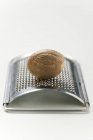 Whole Nutmeg on grater — Stock Photo