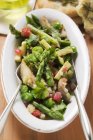 Closeup top view of green asparagus salad with vegetables — Stock Photo