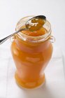 Apricot jam in jar with spoon — Stock Photo