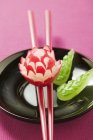 Radish flower on chopsticks — Stock Photo