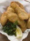 Fish nuggets with lemon wedge and parsley — Stock Photo
