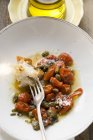 Roasted tomatoes with capers — Stock Photo