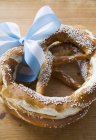 Salted pretzels with blue and white bow — Stock Photo