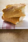 Pieces of baguette on tea towel — Stock Photo