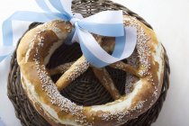 Salted pretzels with blue and white bow — Stock Photo