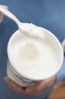 Woman eating yoghurt — Stock Photo