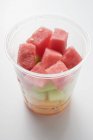 Diced melon in plastic tub — Stock Photo