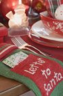 Christmas decorations on setting table — Stock Photo