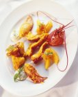 Closeup view of deep-fried lobster with orange segments — Stock Photo