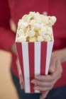 Woman holding popcorn — Stock Photo
