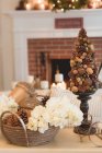 Christmas decorations in front of fireplace — Stock Photo