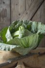 Savoy cabbage on chopping board — Stock Photo