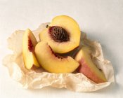 Sliced Peach in Paper — Stock Photo