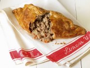 Close up view of Cornish broken pasty on towel — стоковое фото