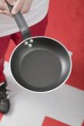 Elevated view of man holding empty frying pan — Stock Photo