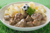 Veal fillets with pasta and football — Stock Photo