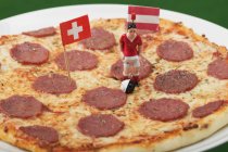 Salami pizza with footballer — Stock Photo