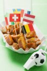 Closeup view of Currywurst with various flags in paper dish — Stock Photo