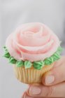 Female hands holding cupcake — Stock Photo
