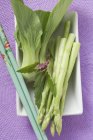Green asparagus and pak choi — Stock Photo