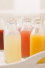 Various different juices in bottles — Stock Photo