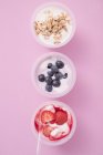 Yoghurts with berries and with cereal — Stock Photo
