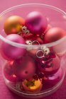 Christmas tree baubles in plastic container — Stock Photo