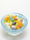 Jelly beans in blue glass dish — Stock Photo