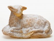 Closeup view of baked Easter lamb with icing sugar on white surface — Stock Photo
