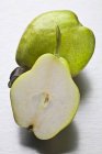 Whole green pear and half — Stock Photo